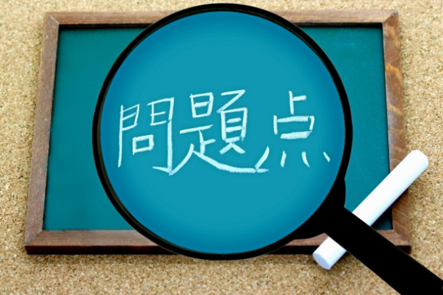 虫眼鏡と「問題点」と記された黒板